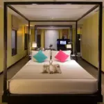 Apsara Suite bedroom with the living area visible beyond